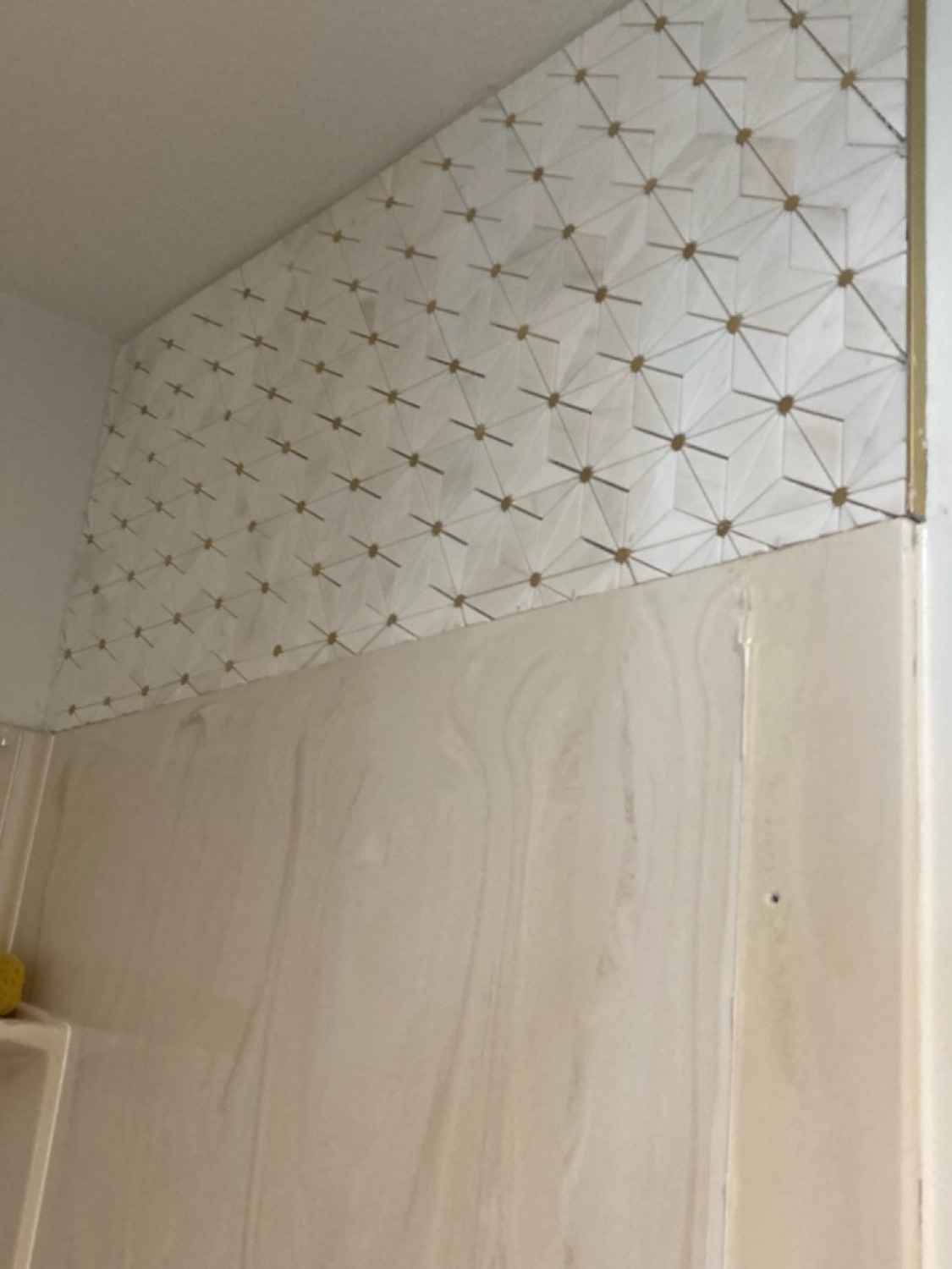 Detailed geometric tile installation in a Kansas bathroom.