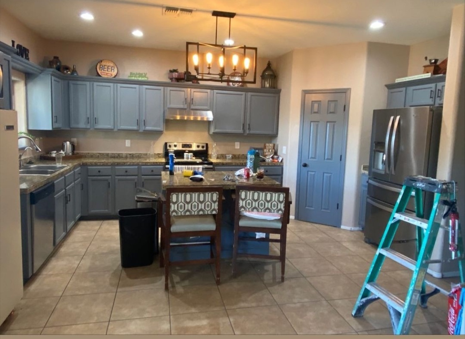 Completed kitchen remodel with gray cabinetry and a central island.
