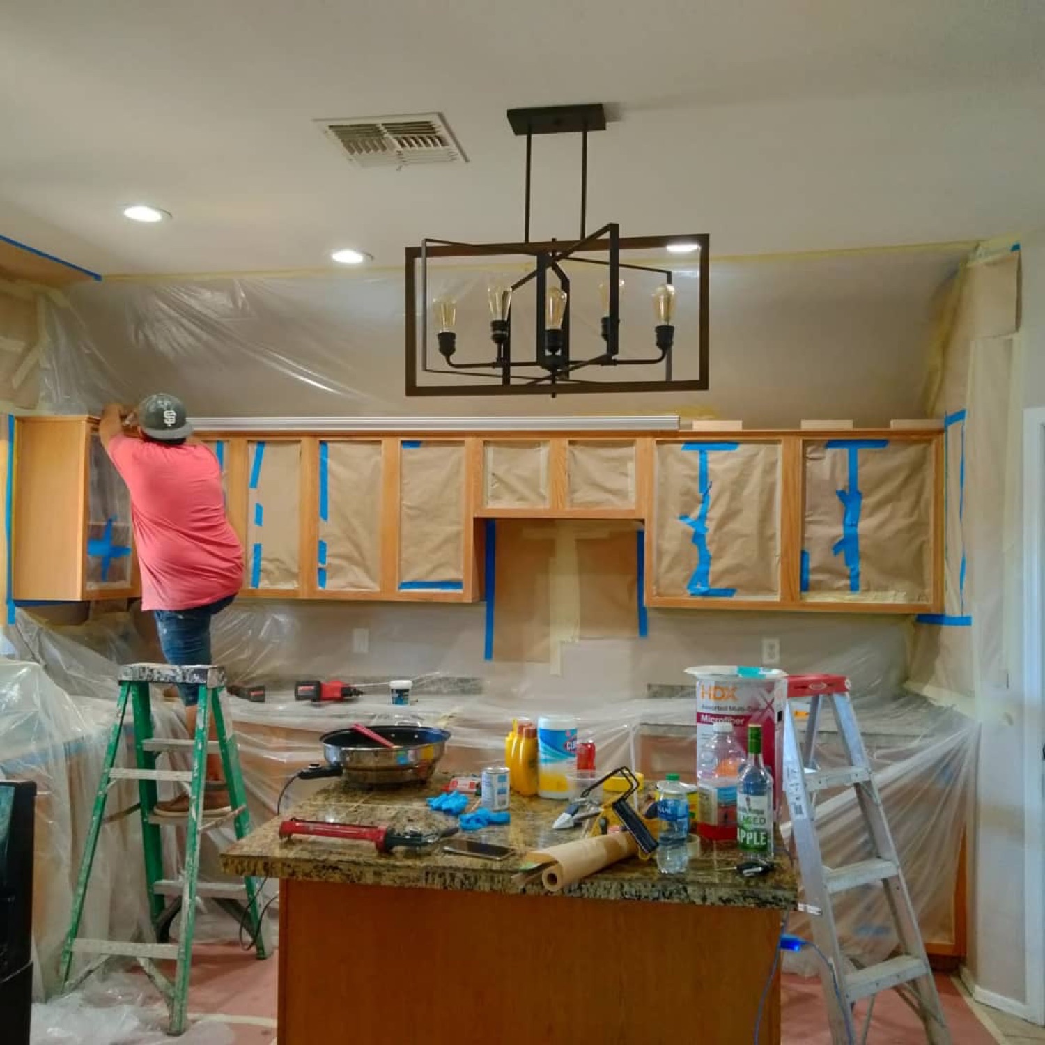 Kitchen remodel in progress, with cabinets masked for finishing.