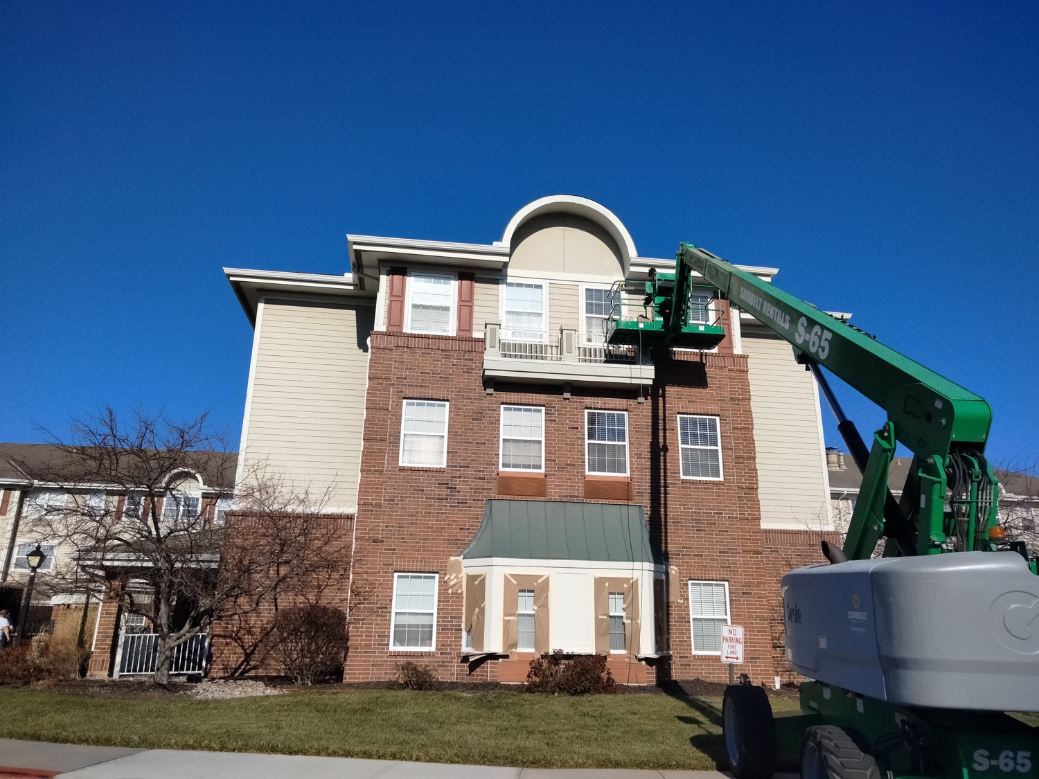 Multi-story building during exterior painting in Overland Park, Kansas.