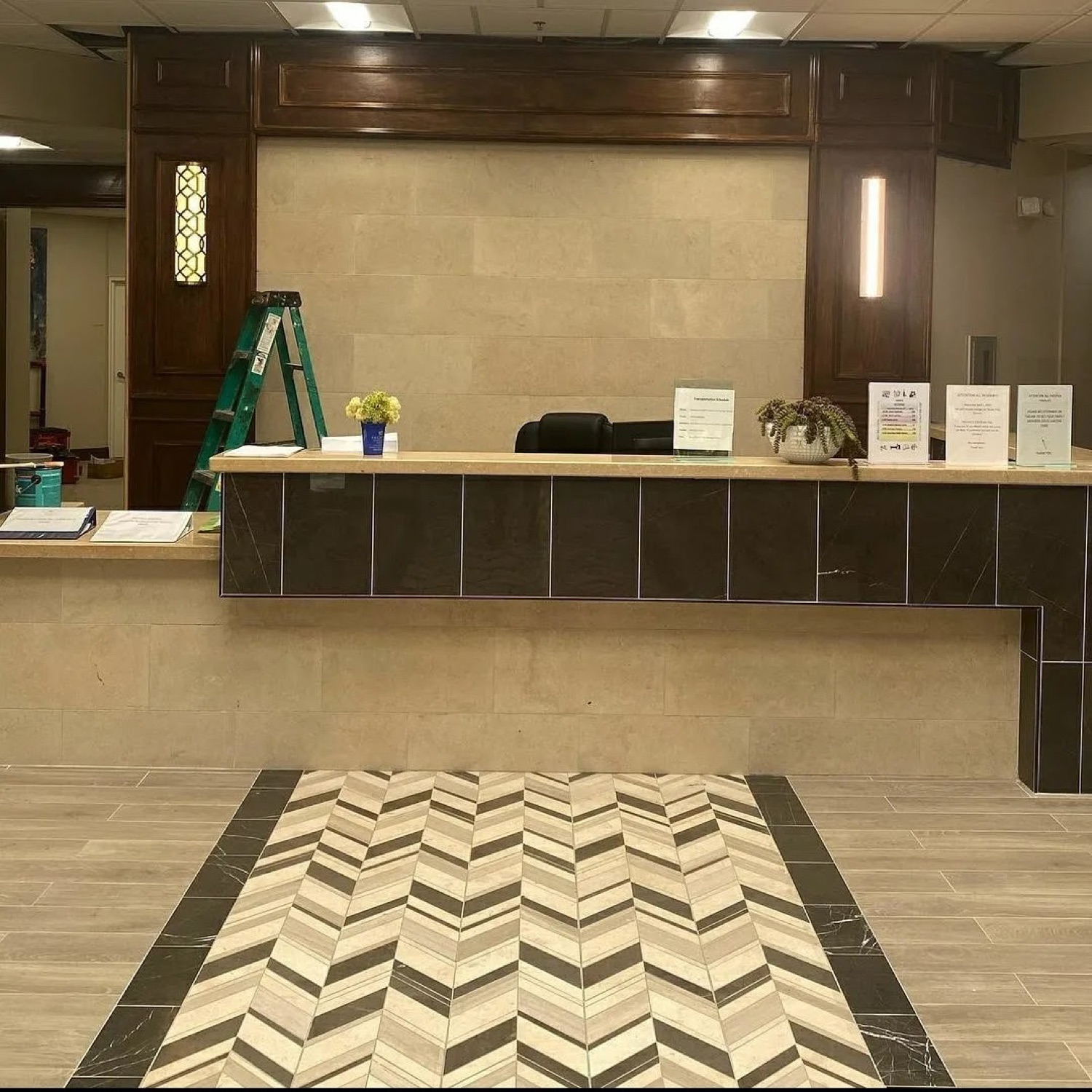 Custom tile and flooring around a commercial reception desk.