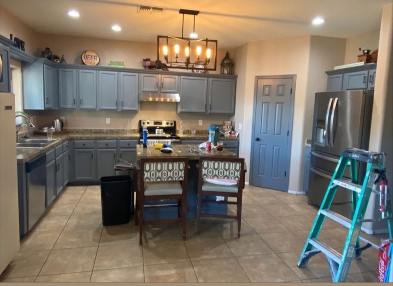 Completed kitchen remodel with gray cabinetry and a central island.