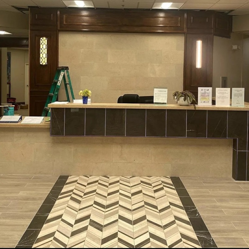 Custom tile and flooring around a commercial reception desk.